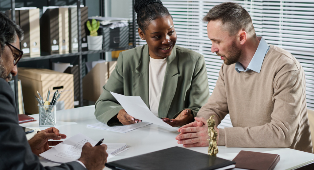 A team reviews documents together, illustrating how SaaS leaders define invisible value by uncovering the real outcomes users can't articulate but rely on every day.