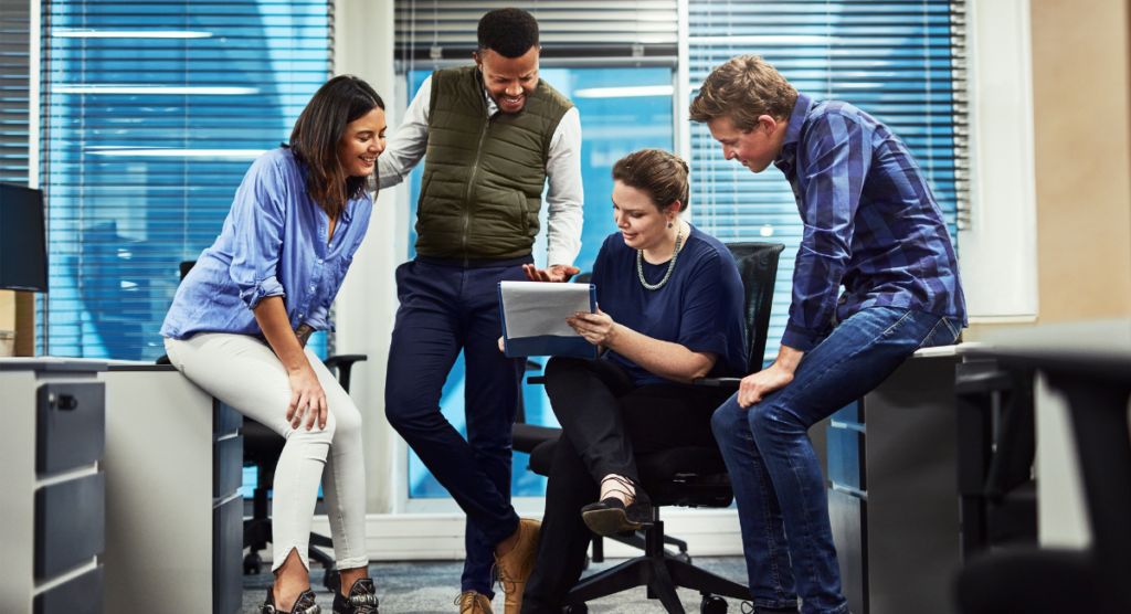 A team reviews product insights together, highlighting how shared understanding and clearer product stories help move SaaS users beyond the 30 percent adoption stall point.