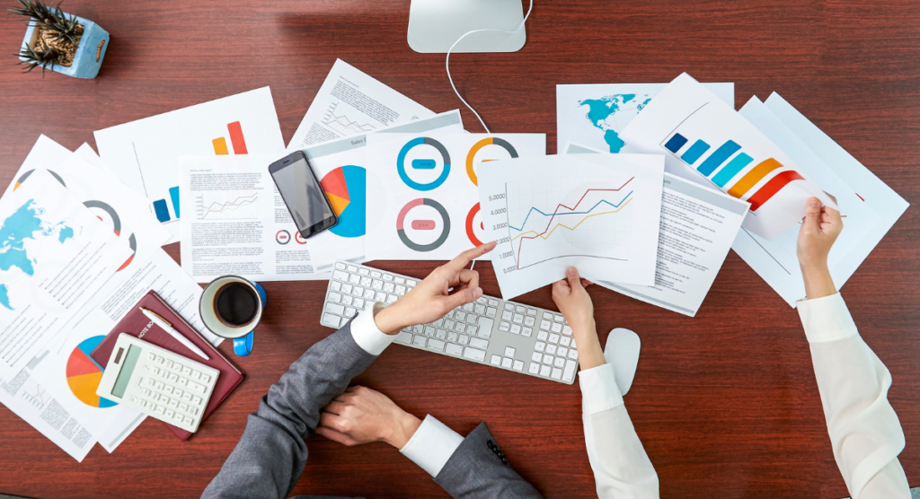 Team reviewing mixed performance charts that reflect how unclear product value leads to wasted ad spend and stalled growth.